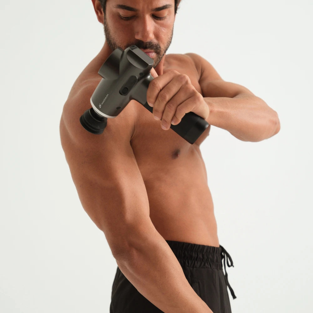 WAGNUM Massage gun being used to release arm muscle tention.