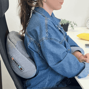Shiatsu massager being used  for back pain at the office.