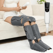 Air compression leg massager with smart control being used by woman at the sofa.